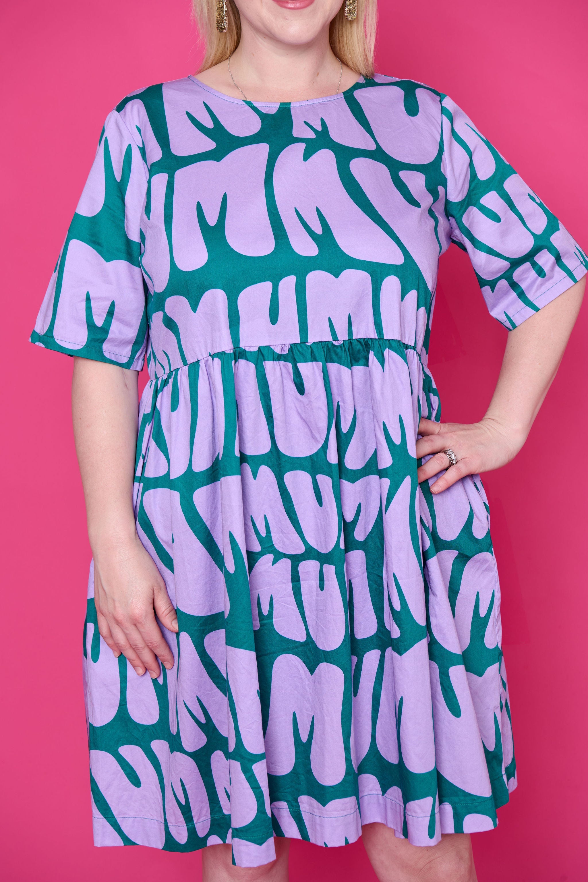 Model wearing Toomi Mum Vibes purple and teal knee-length cotton babydoll print dress