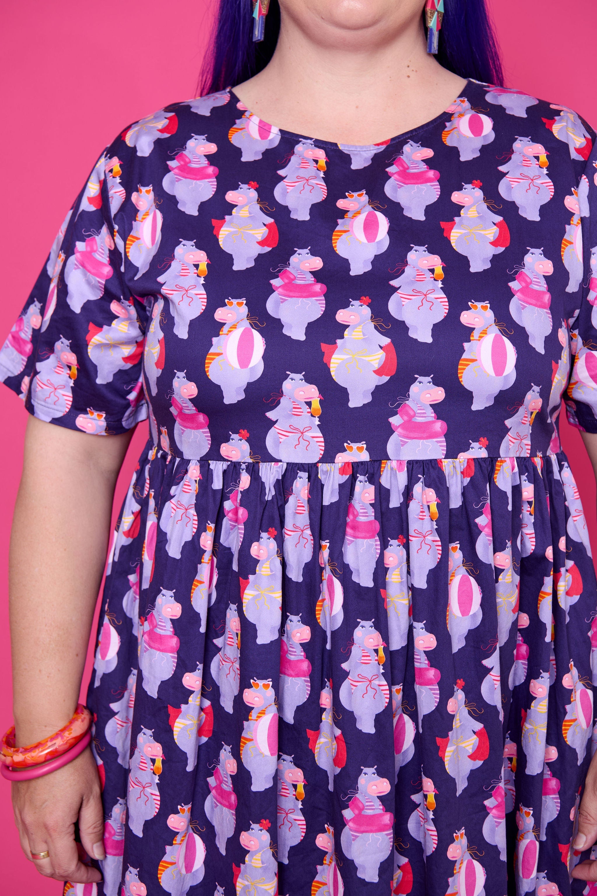 Model wearing Toomi Tess the Hippo cotton midi babydoll dress in colourful hippo print