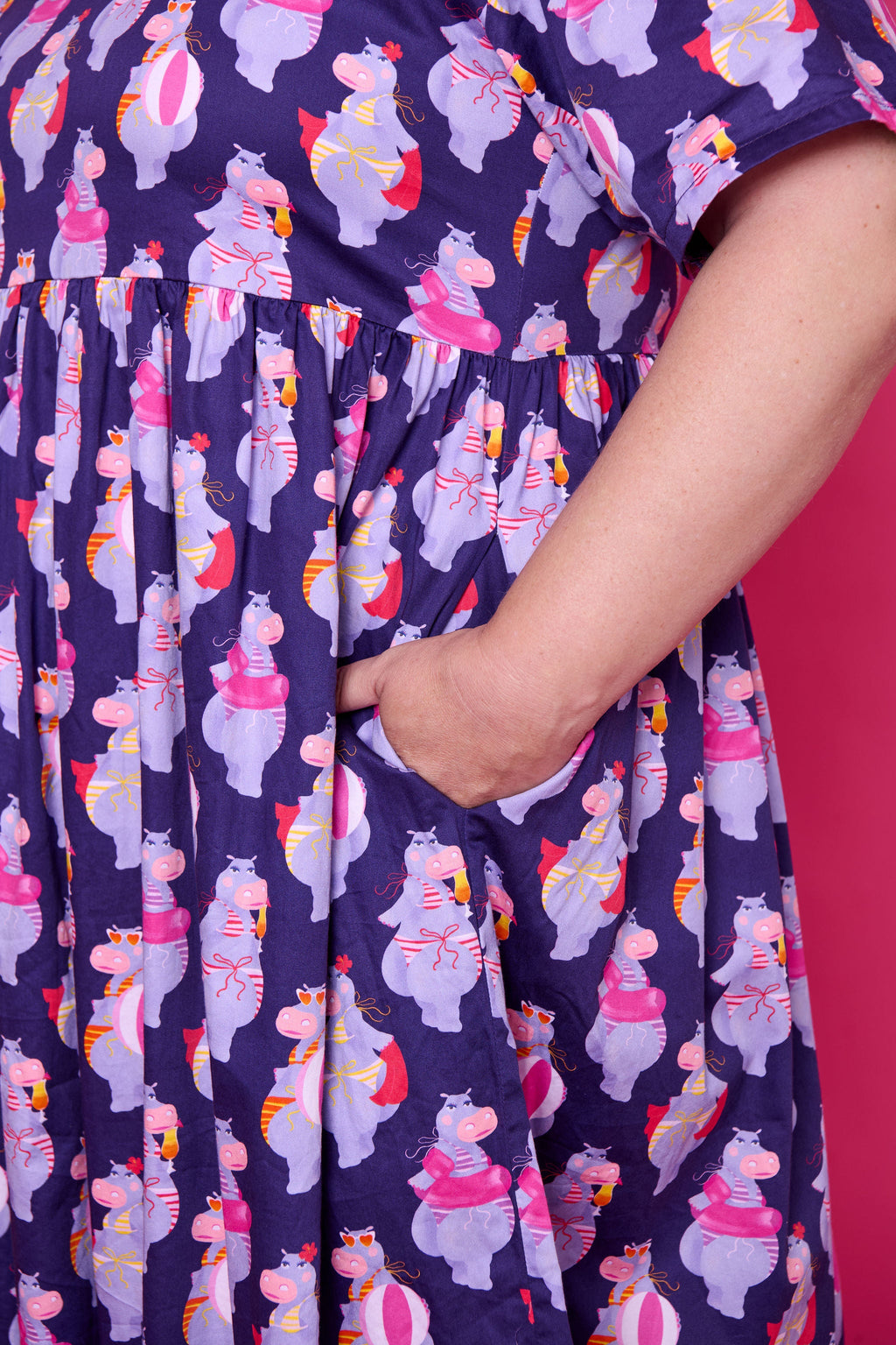 Model wearing Toomi Tess the Hippo cotton midi babydoll dress in colourful hippo print