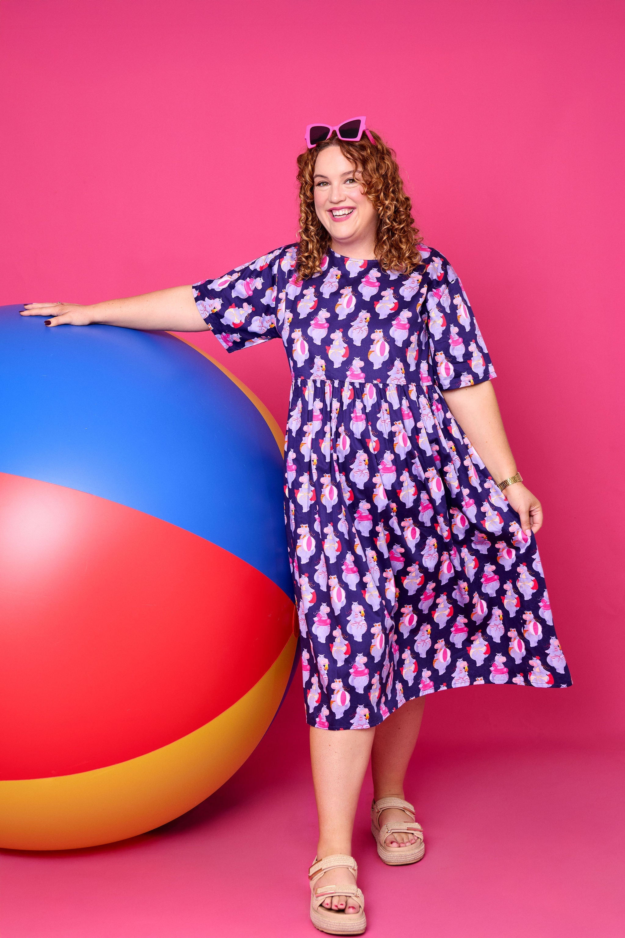 Model wearing Toomi Tess the Hippo cotton midi babydoll dress in colourful hippo print