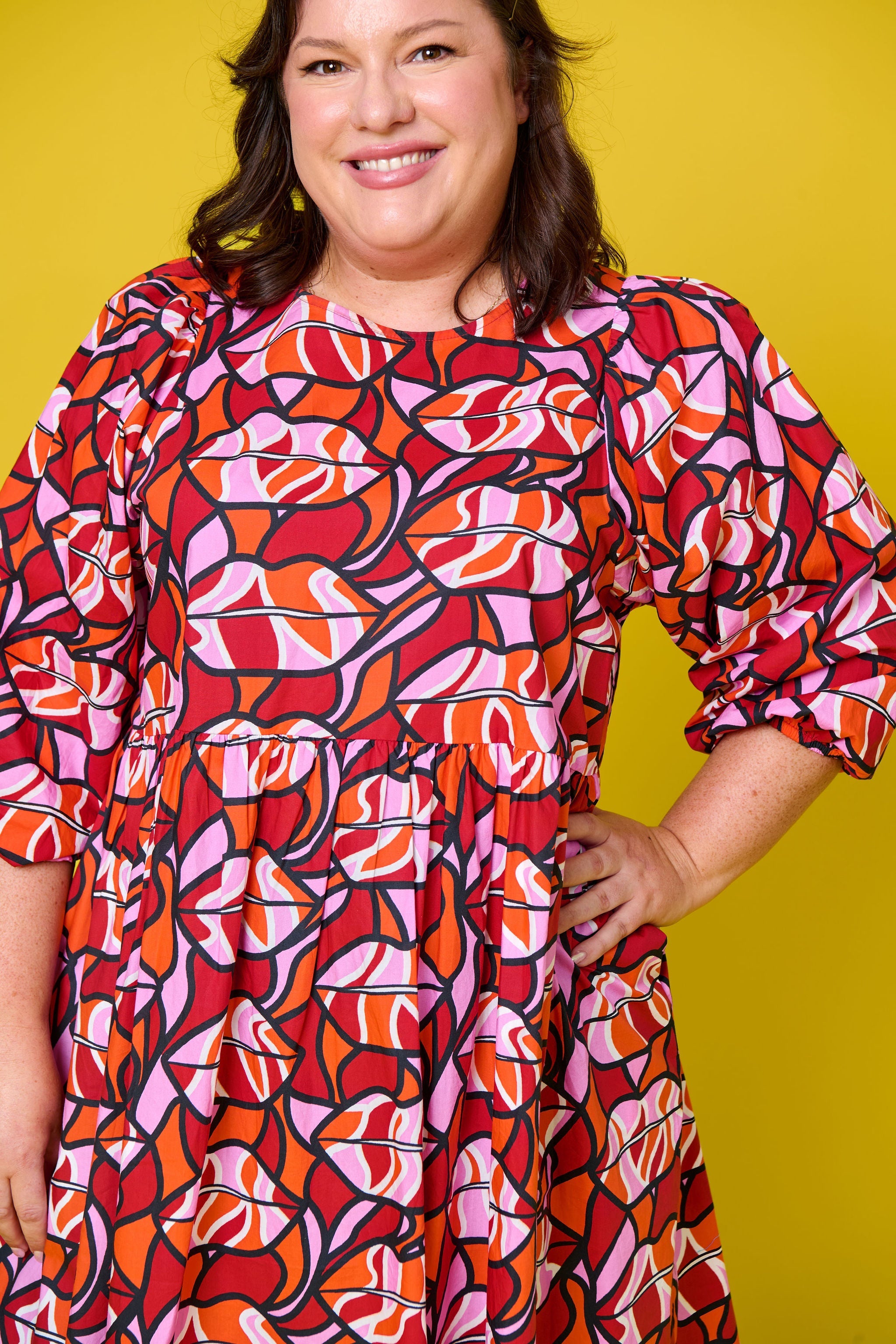 Model wearing Toomi Retro Lips cotton mini babydoll dress in red lips print
