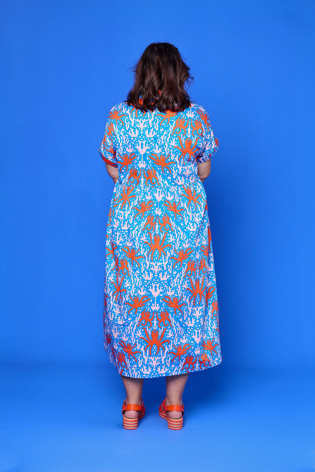 Model wearing Toomi Octopus Friends colourful v-neck cotton maxi dress in hand-illustrated octopus print