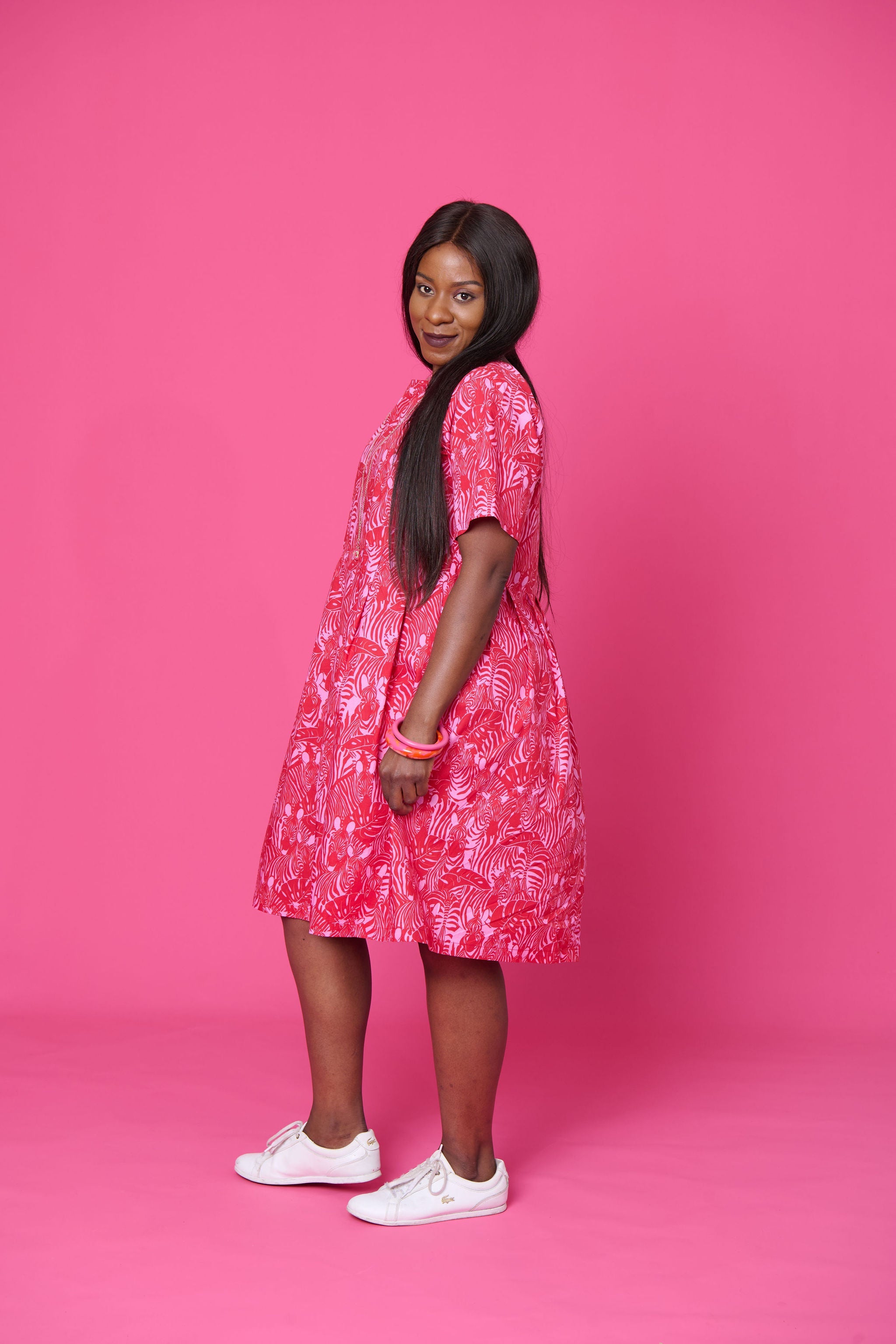 Model wearing Toomi Zebra Garden cotton maxi dress with pleated skirt in colourful zebra print