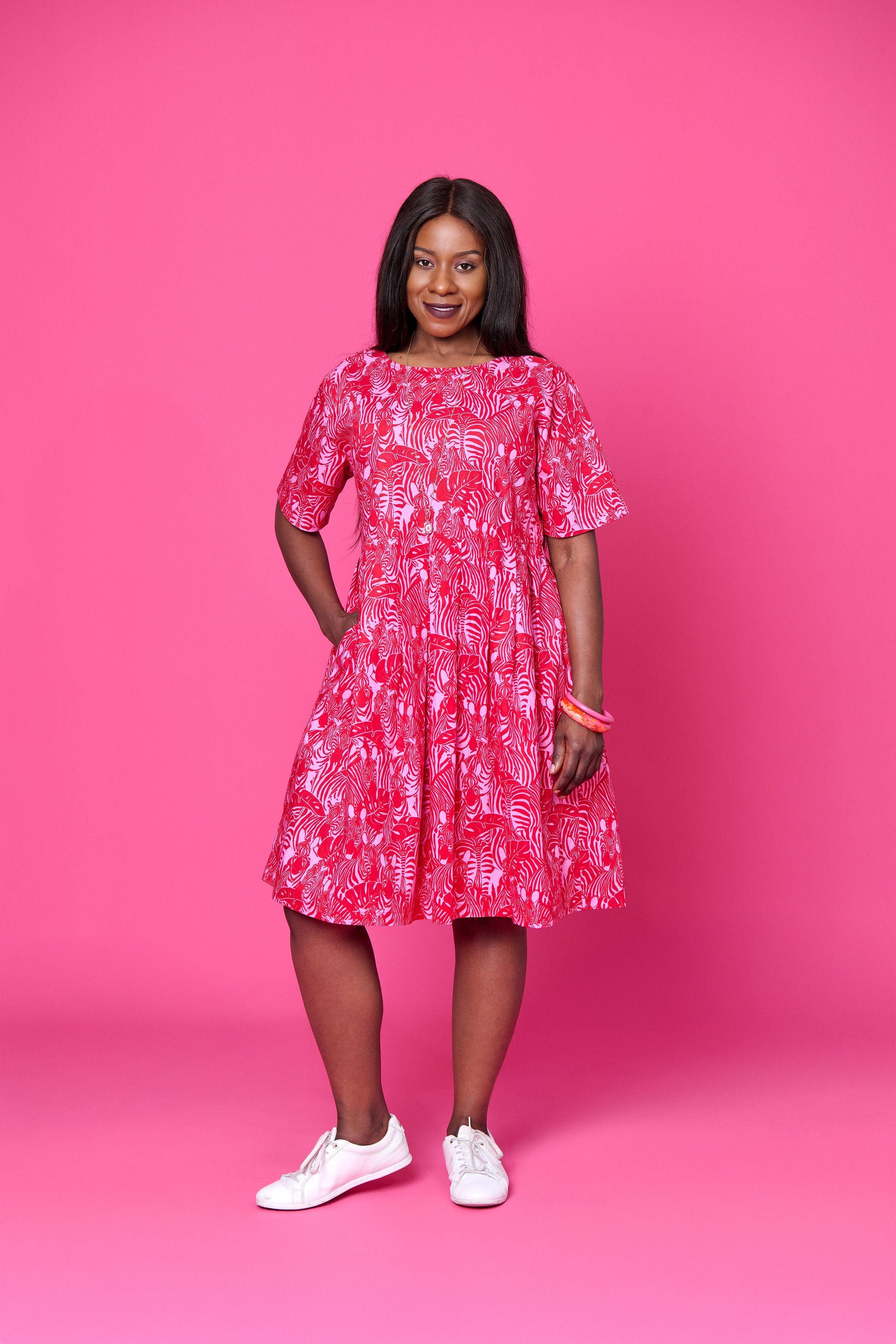 Model wearing Toomi Zebra Garden cotton maxi dress with pleated skirt in colourful zebra print