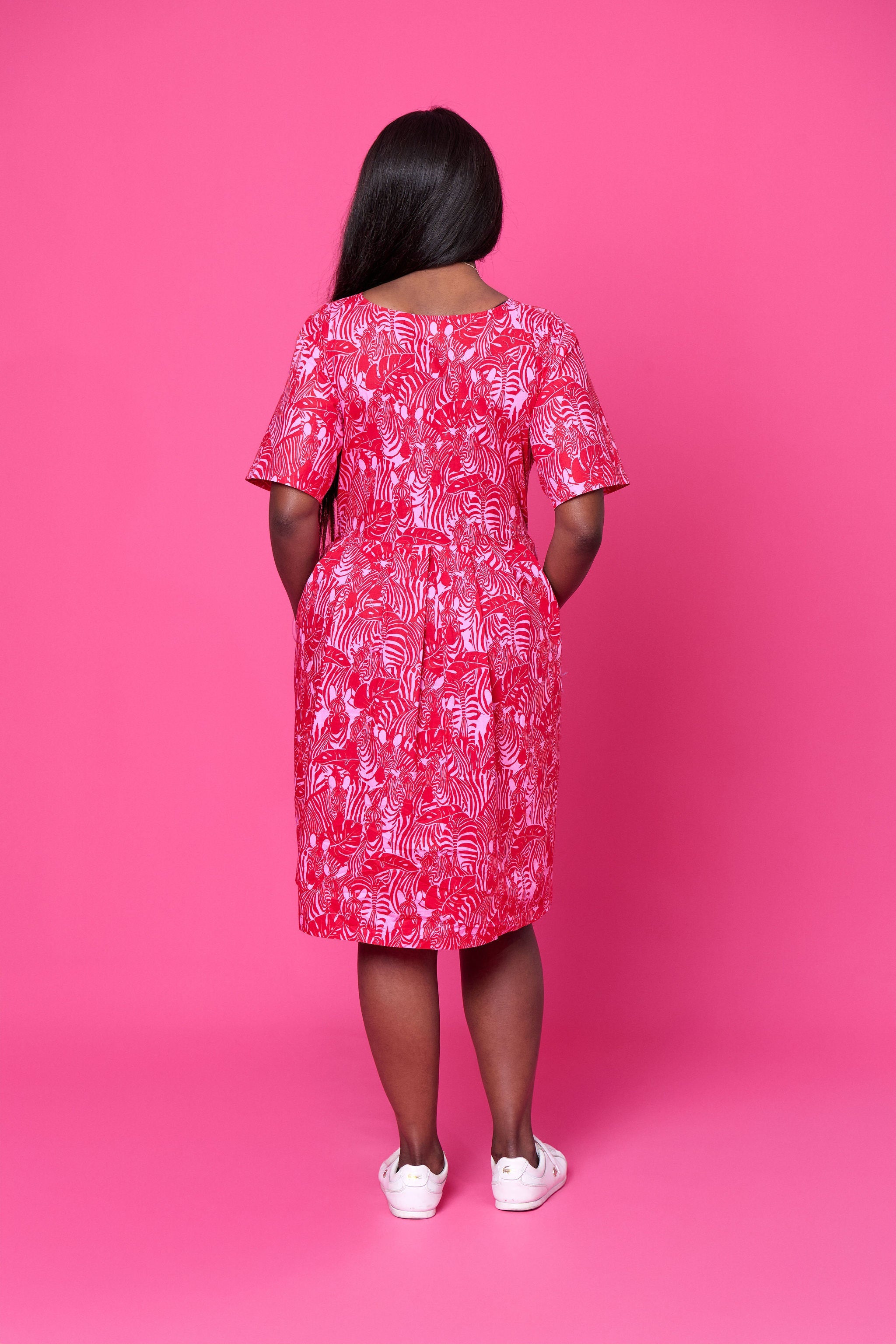 Model wearing Toomi Zebra Garden cotton maxi dress with pleated skirt in colourful zebra print