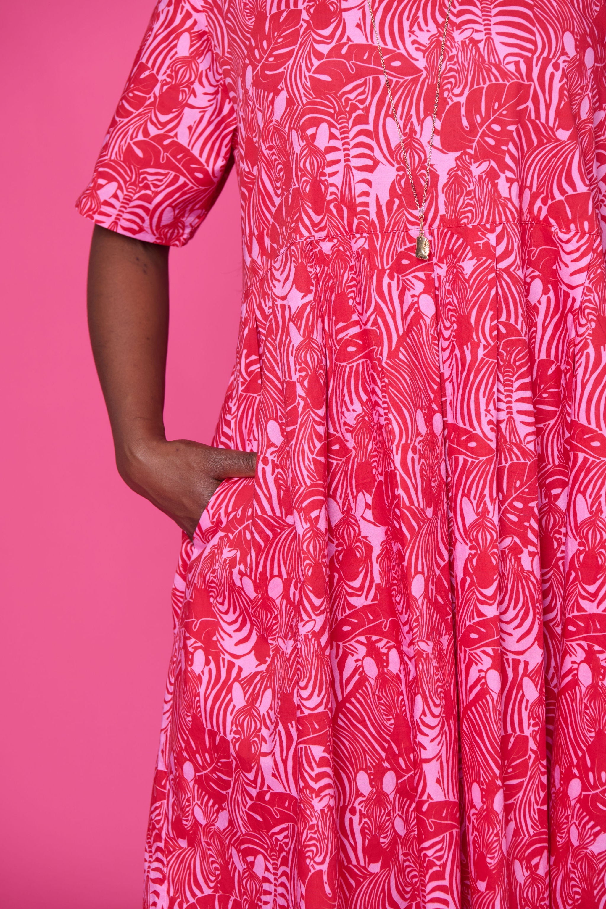 Model wearing Toomi Zebra Garden cotton maxi dress with pleated skirt in colourful zebra print