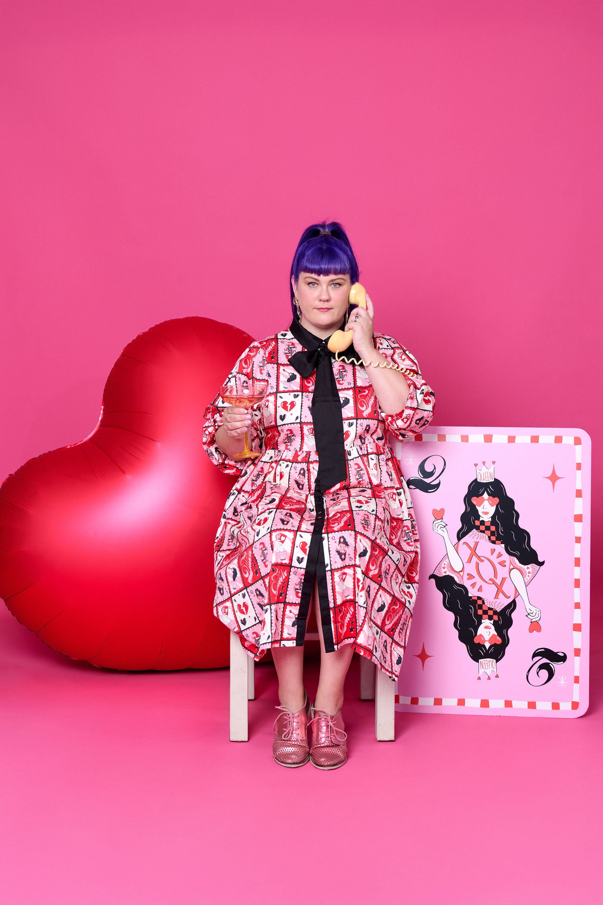 Model wearing Toomi Queen of Hearts cotton maxi babydoll dress in hand-illustrated heart print