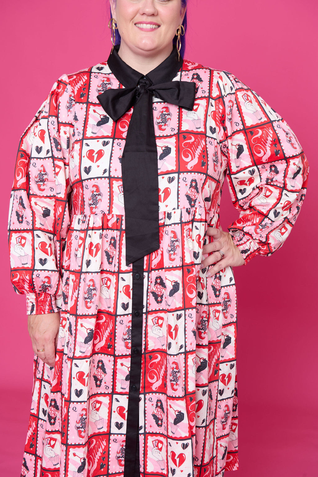 Model wearing Toomi Queen of Hearts cotton maxi babydoll dress in hand-illustrated heart print