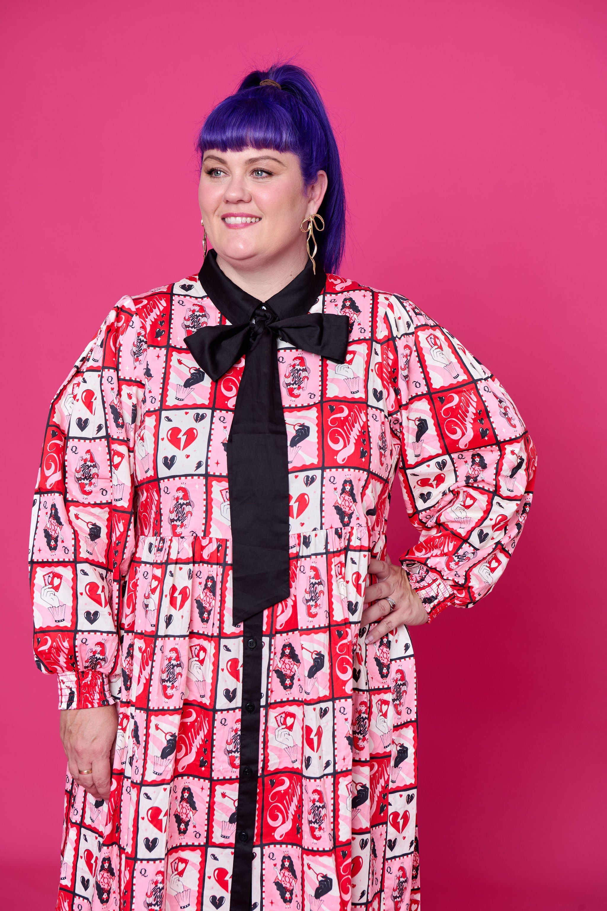 Model wearing Toomi Queen of Hearts cotton maxi babydoll dress in hand-illustrated heart print