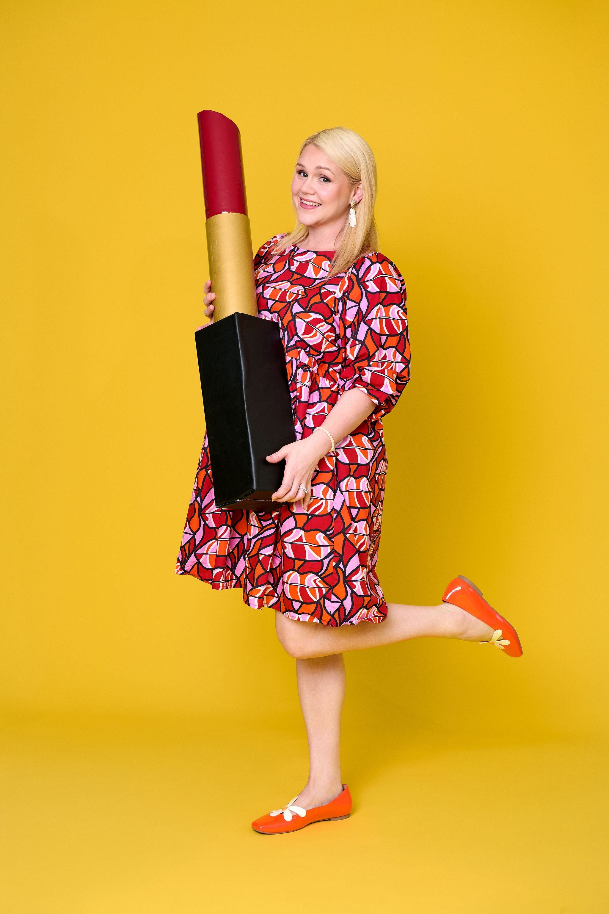 Model wearing Toomi Retro Lips cotton mini babydoll dress in red lips print