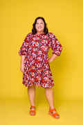 Model wearing Toomi Retro Lips cotton mini babydoll dress in red lips print