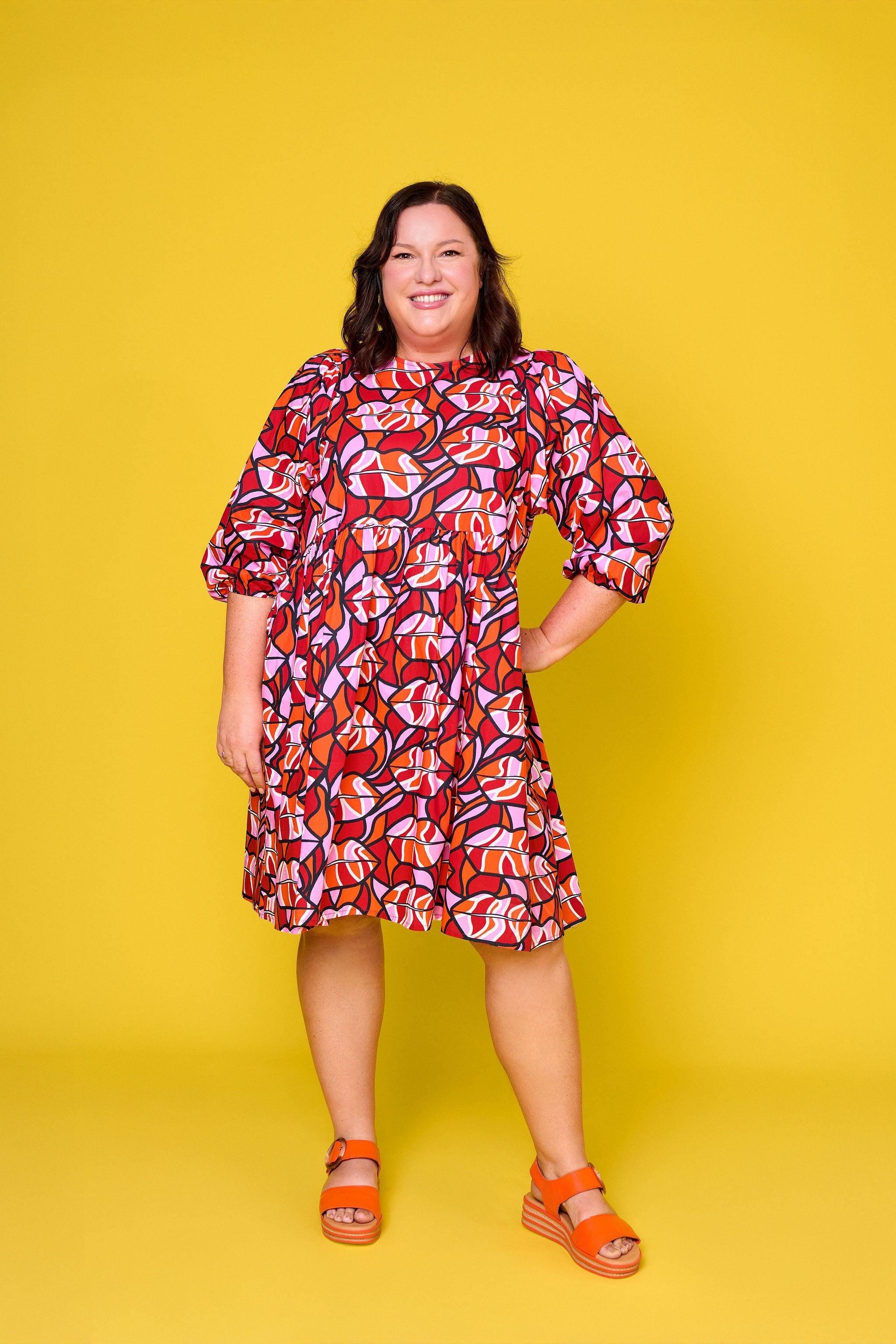 Model wearing Toomi Retro Lips cotton mini babydoll dress in red lips print