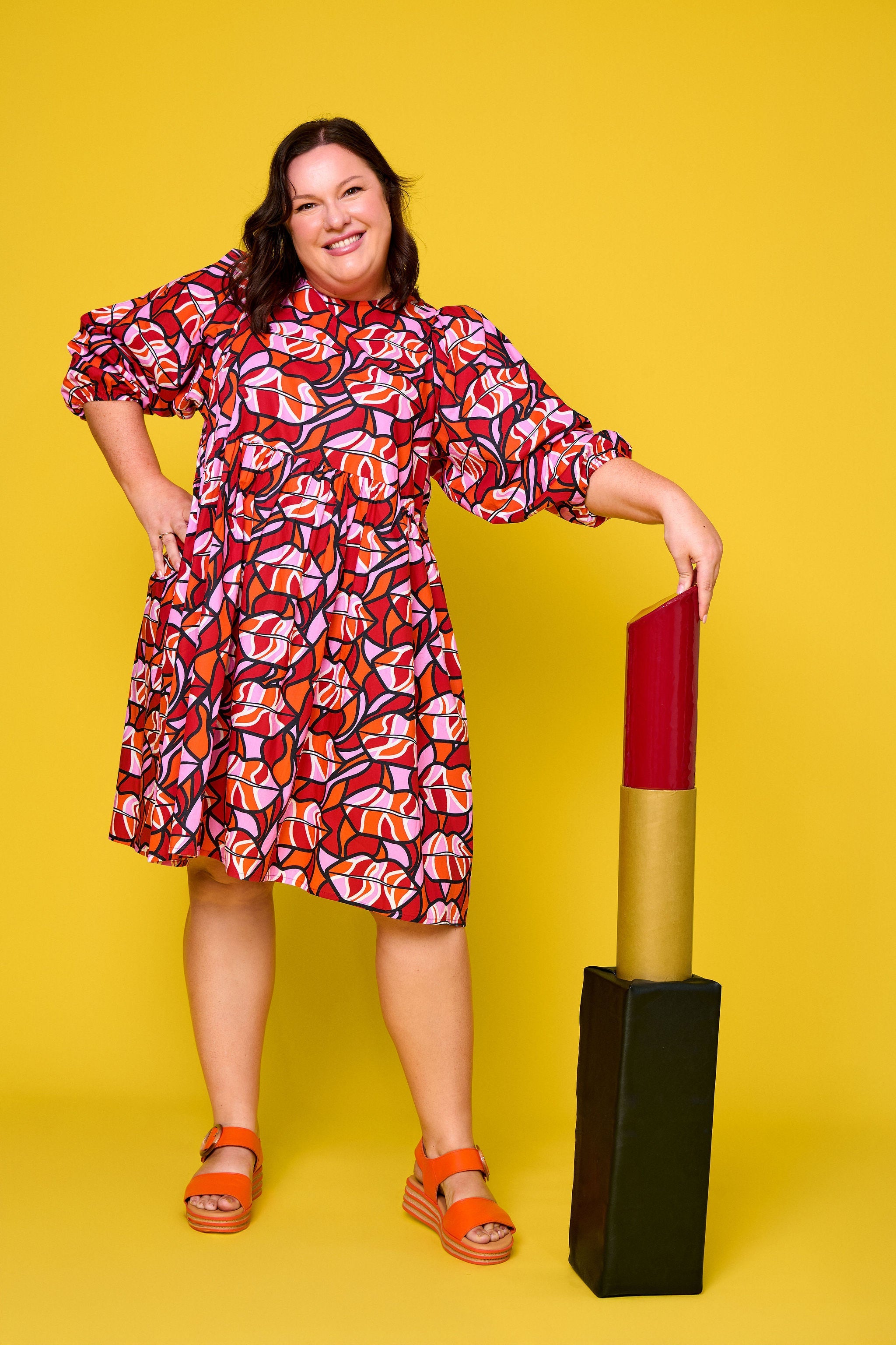 Model wearing Toomi Retro Lips cotton mini babydoll dress in red lips print