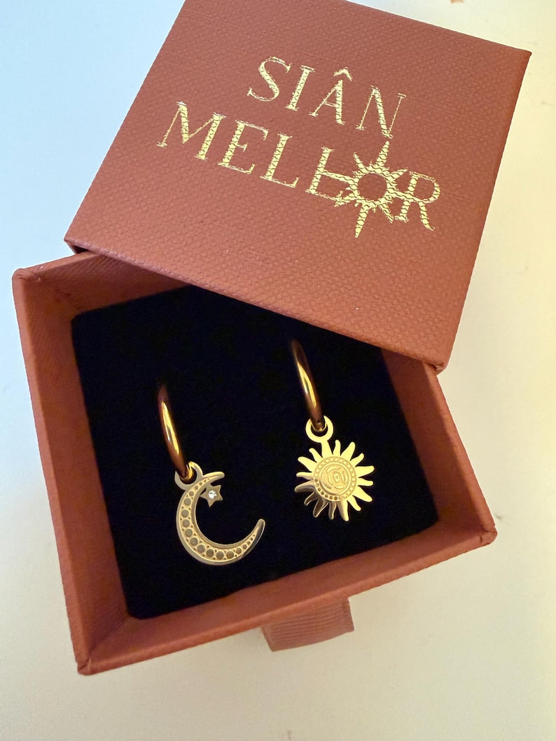 Gold sun and moon huggie hoops in gift box