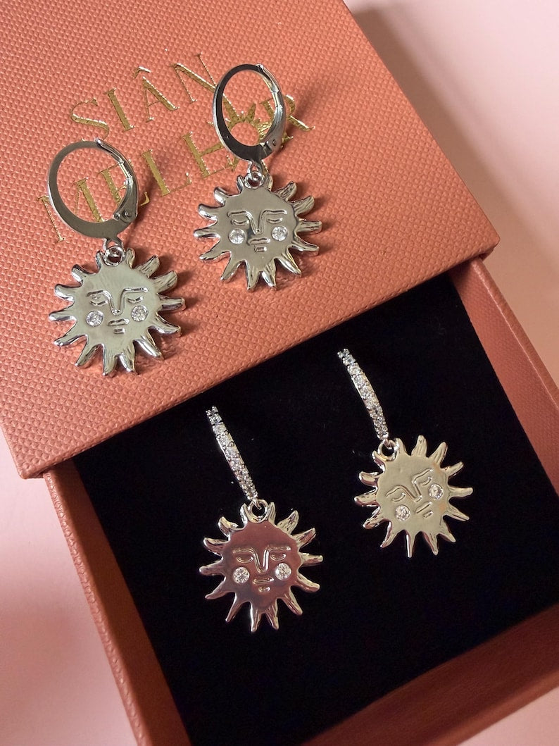 Silver sun with gem cheeks huggie hoops