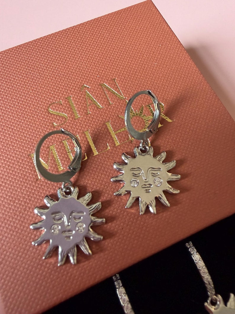 Sun face huggie hoops on gift box